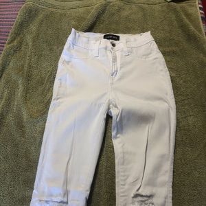 White jeans with rips at the kness